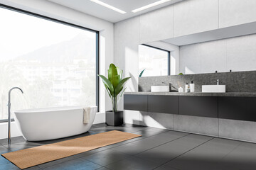 Corner view on dark bathroom interior with bathtub, panoramic window