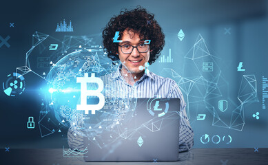 Handsome curly businessman is working on laptop at office workplace