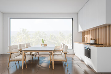 Light kitchen interior with table and chairs, appliances and panoramic window