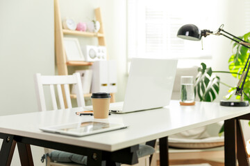 The cosy workplace of a businesswoman working from home.