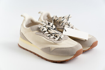 modern sneakers made of combined materials and colors with a high sole and a label with copy space....