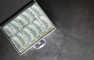 A metal suitcase filled with American 100 dollar bills. Double exposure. Investment, bribe, corruption concept.