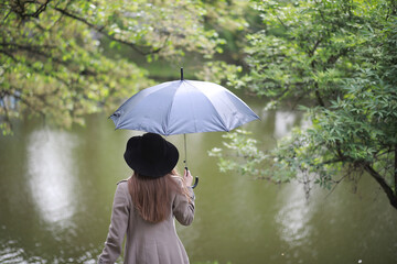 Young girl in a coat in a spring park