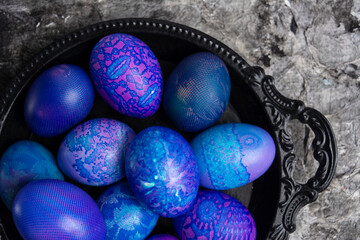 Easter eggs. Blue-purple Easter egg in bowl
