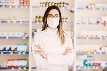 A proud female pharmacy worker waiting for customers who need help.