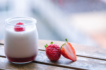 yogurt with strawberries on the wooden table