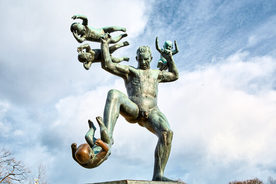 Oslo, Norway - March 30, 2022: Bronze statue of nude man with children "Father which are playing with childrens" in Vigeland Park (Frogner Park)