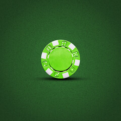 Green poker chip, on a dark green background. Gambling.