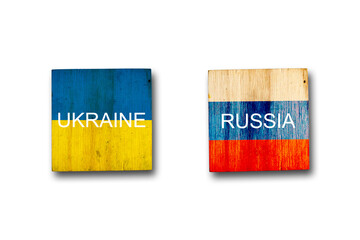 Flags of Ukraine and Russia on wooden blocks. Isolated on white background. Conflict between...