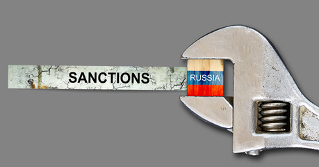 Sanctions. Flag of Russia on a wooden block, clamped with a wrench. Isolated on a gray background....