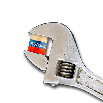 Flag of Russia on a wooden block, clamped with a wrench. Isolated on white background. Sanctions. country isolation. economic blockade. Economy. Politics.