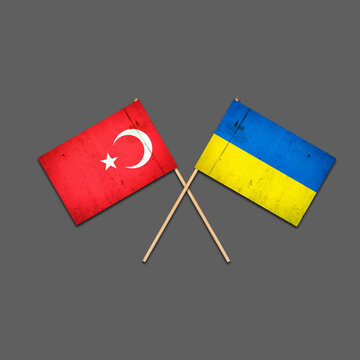 Flags of Turkey and Ukraine, on wooden sticks. Isolated on a gray background. International political relations. Commonwealth. Support. Political Economic