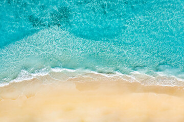 Summer seascape beautiful waves, blue sea water in sunny day. Top view from drone. Sea aerial view, amazing tropical nature background. Beautiful bright sea with waves splashing and beach sand concept - obrazy, fototapety, plakaty