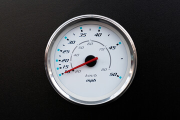 Close-up of a speedometer on a black background