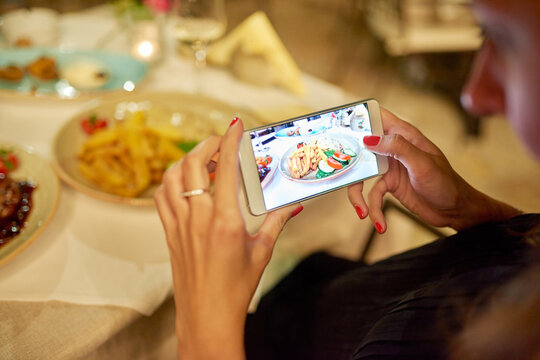 Im sharing this meal online. Cropped shot of an unrecognizable woman taking a picture of her food.
