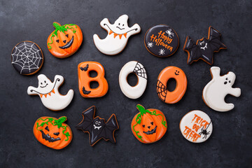 Halloween gingerbread cookies on dark stone background. Bright homemade cookies for Halloween party - 498028656