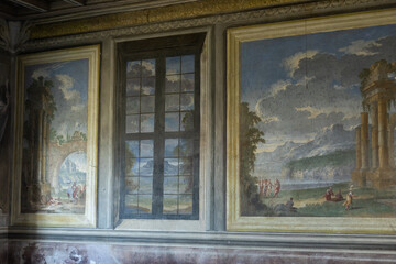 a beautiful painting on the walls in an old antique villa