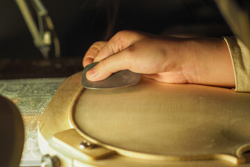 luthier working on a new violin in his workshop