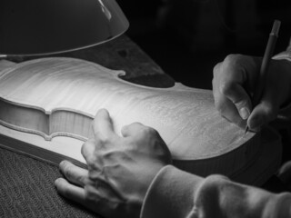 luthier working on a new violin in his workshop
