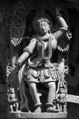Stone Sculpture of Beautiful Female (Madanikas) with selective focus, 12th century Hindu temple, Ancient stone art and sculptures in each pillars, Chennakeshava Temple, Belur, Karnataka, India.