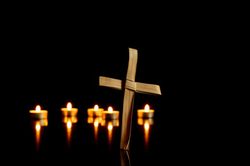 hand made cross with candles on black background