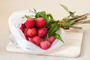 A bouquet of lychee in a plastic bag.