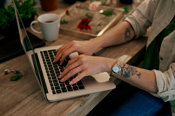 I turned my passion into a successful business. Cropped shot of an unrecognizable florist working on a laptop inside her store.