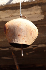 Old, vintage bell for animals in the pasture.