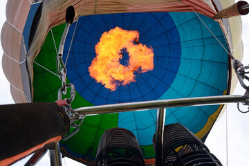 Gas burner gives flame filling the canopy of a balloon with hot air. Festival of balloons