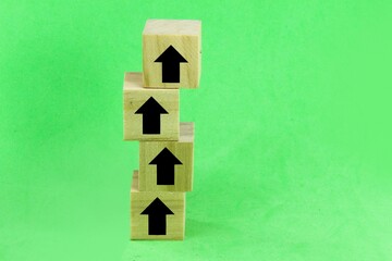 wooden cubes with the direction according to the arrow winding upwards. concept towards success