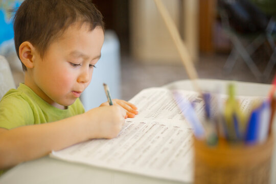 A little asian boy is doing solfeggio and music lessons