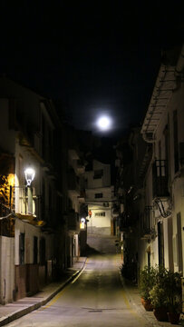 Full moon over village street