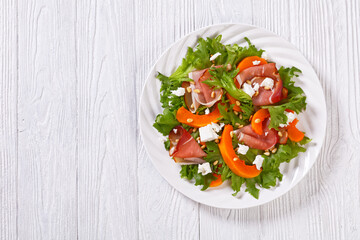 pumpkin salad with lettuce, crumbled cheese, ham