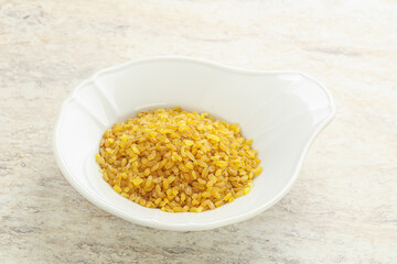 Raw bulgur in the bowl