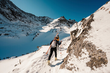 Mountaineer backcountry ski walking ski alpinist in the mountains. Ski touring in alpine landscape...