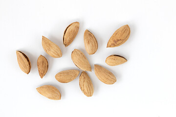 heap of unpeeled almonds isolated on white background
