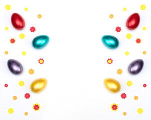 Bright painted easter eggs with paper flowers on white background. Happy Easter concept. Flat lay style with copy space