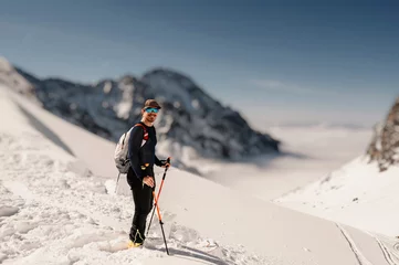 Foto op Canvas Mountaineer backcountry ski walking ski alpinist in the mountains. Ski touring in alpine landscape with snowy trees. Adventure winter sport. High tatras, slovakia landscape © alexanderuhrin