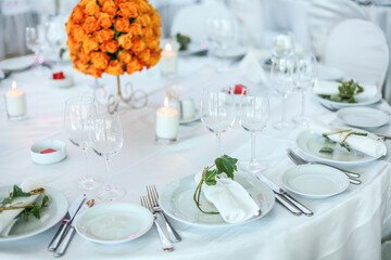Holiday table setting decorated with flowers and candles.