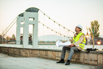 Looking and thinking about the plans alone by the river