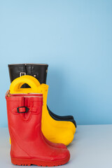 Rubber boots recycling. used shoes on a blue background. concept of sustainable lifestyles and...