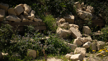 abandoned bench covered with rocks 