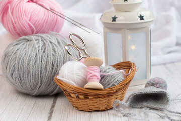 Fototapeta na wymiar balls of yarn lie in a wicker basket with knitting needles. Needlework, handmade