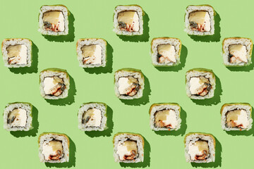 Sushi rolls pattern on mint background.