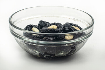 Prunes with cheese in a glass plate