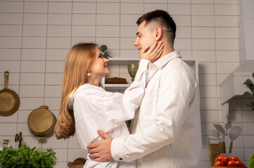 Fototapeta premium Happy love couple hugging with joy at home kitchen interior.