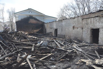 charred ruins of a burnt-out wooden building
