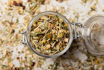 A jar of herbal tea on a light gray background. Detox and immunity drink. A mixture of herbs. Copy...