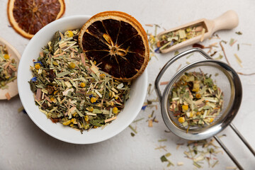 Herbal tea in a white ceramic bowl and spices on a light background. tea for immunity and detox.  space for text. Tea ceremony