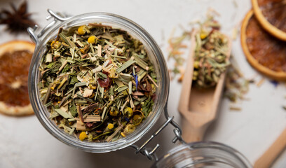 A jar of herbal tea on a light gray background. Detox and immunity drink. A mixture of herbs. Copy...